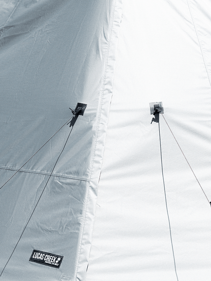 Close up shop of the Lucas Creek 180 Fantail free standing awning showing the tie down points to allow the wall kit to keep its shape 